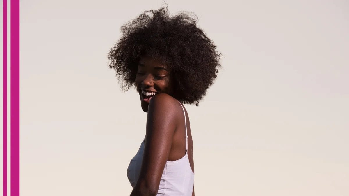 A happy client dances around with a smile on her face–her praise will help her stylist's beauty business growth.