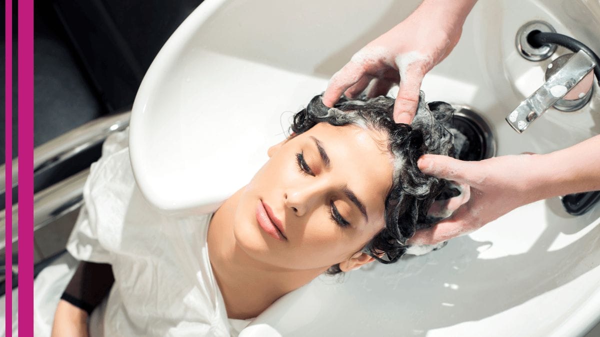 A client gets her hair washed in a salon suite where her stylist works.