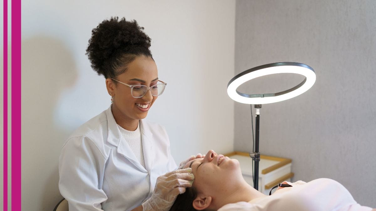 An esthetician works on her client's brows in her studio.