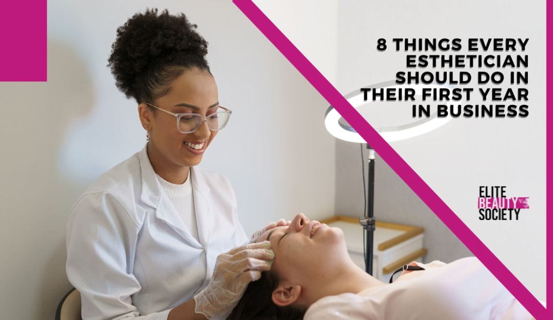 An esthetician looks at her client's skin in her office using a ring light.