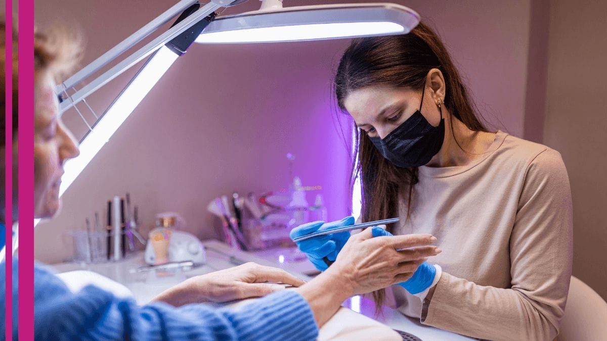 A client lets her nail tech implement her latest nail tech tips on her nails.