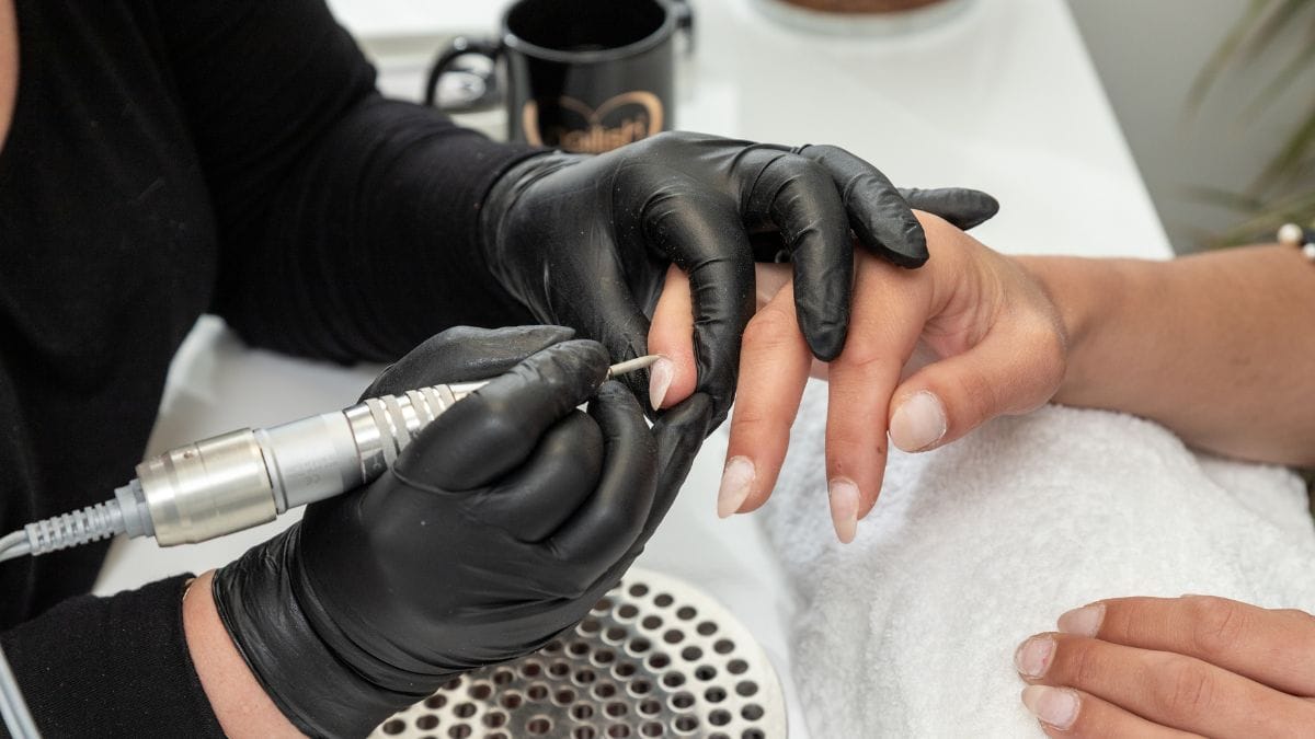 A nail tech preps her clients 4th of july nails.