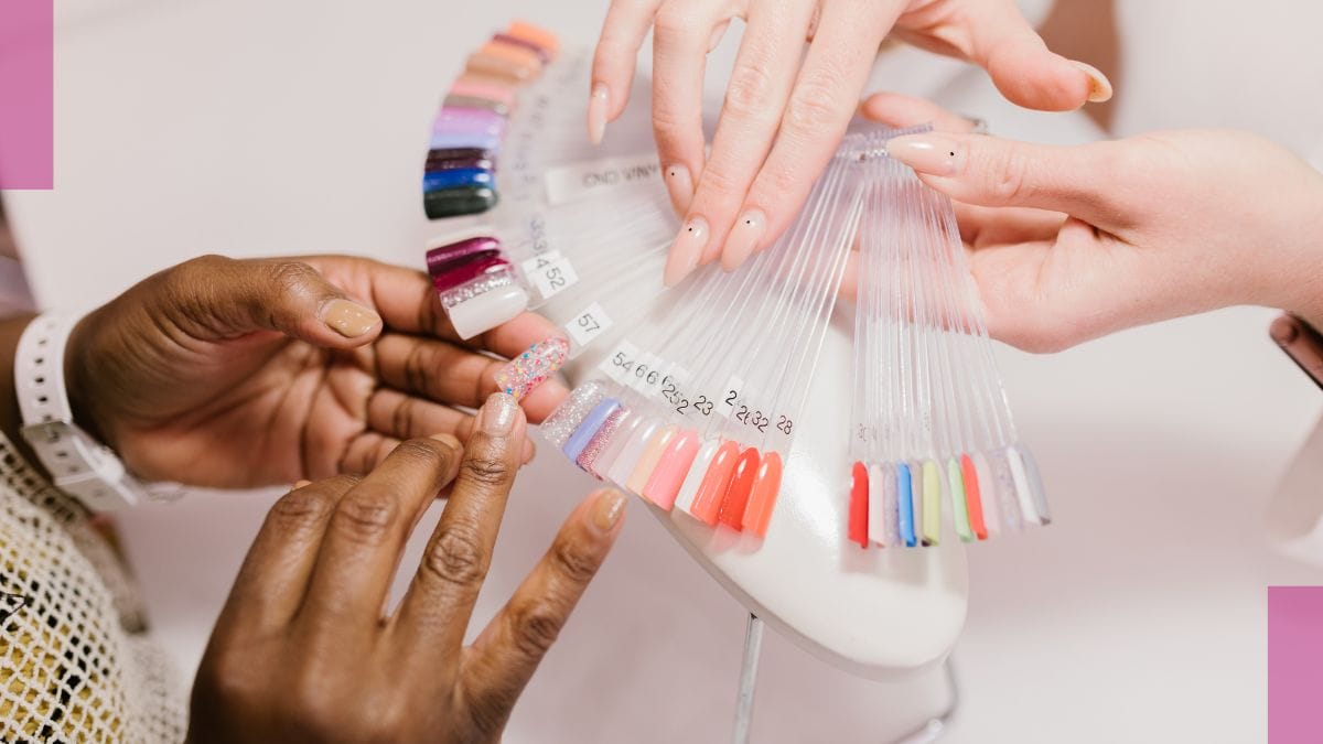 A nail tech shows her clients 4th of July nails.
