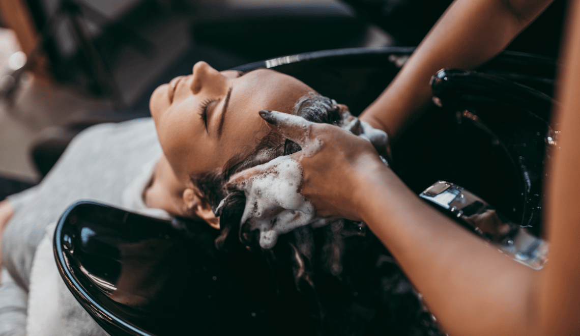 A woman shampoos her clients hair
