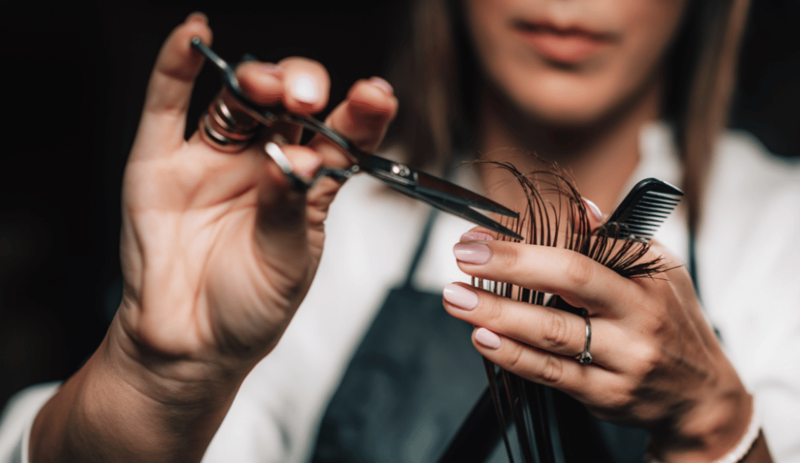 A hair dresser trims hair