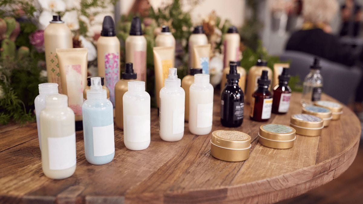 Beauty products displayed on an artful sales table (like in this image) is a great, go-to strategy to sell your product line in your salon suite.