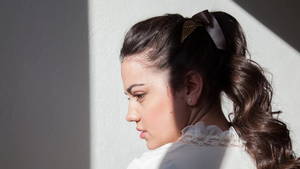 A client shows off her high barbie ponytail, a fall beauty trend. 
