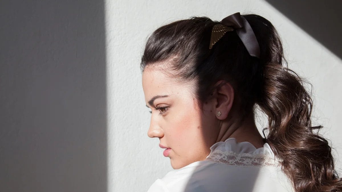 A client shows off her sleek ponytail from her thanksgiving beauty appointment.