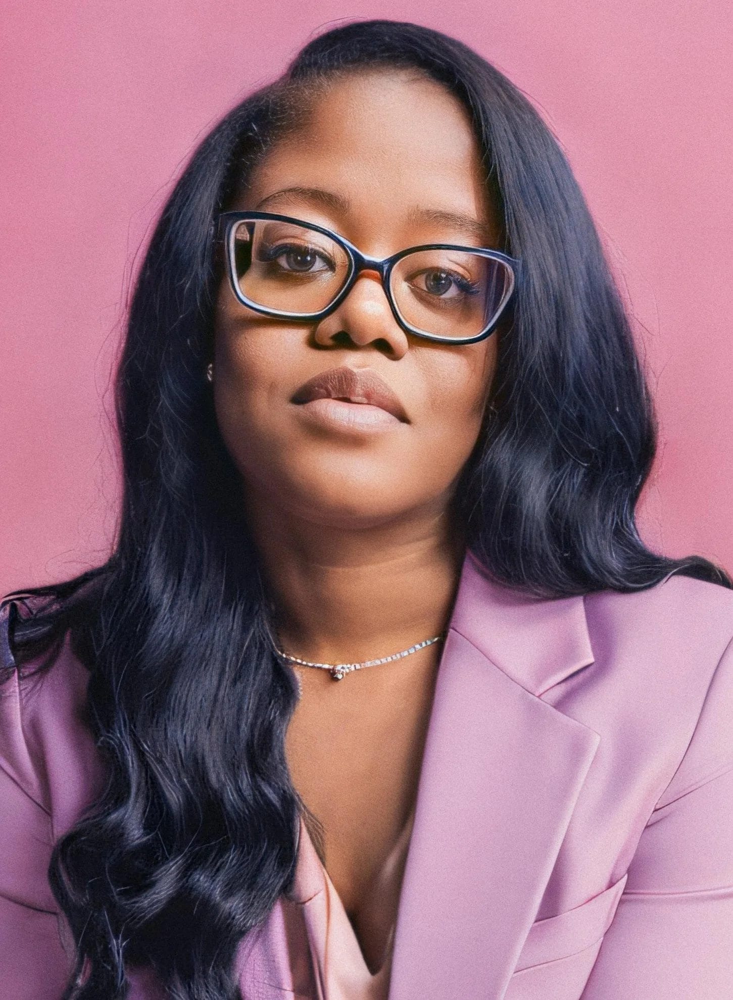Black beauty pro Georgenia poses in a pink blazer.
