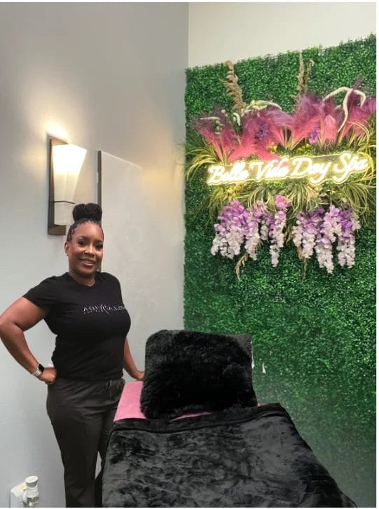 Black beauty pro Ebony Overstreet poses with her esthetics chair at her salon and spa.