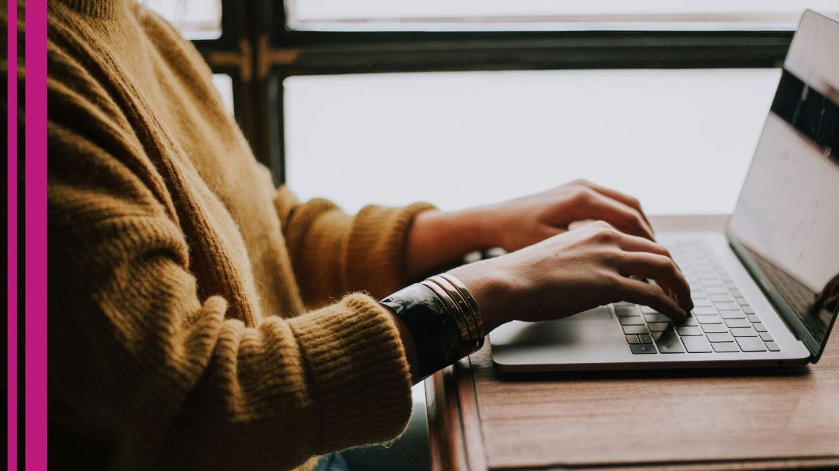 A stylist works on her salon marketing plan while on her laptop.