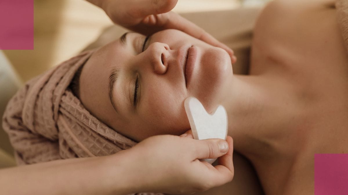 A mobile esthetician applies a gua sha technique in her client's home.
