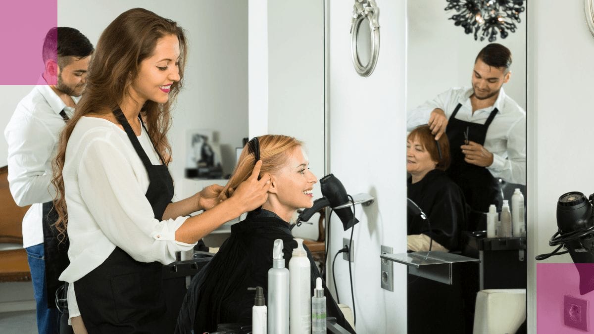 A beauty pro shows off her client's new look to her while in her beauty business.
