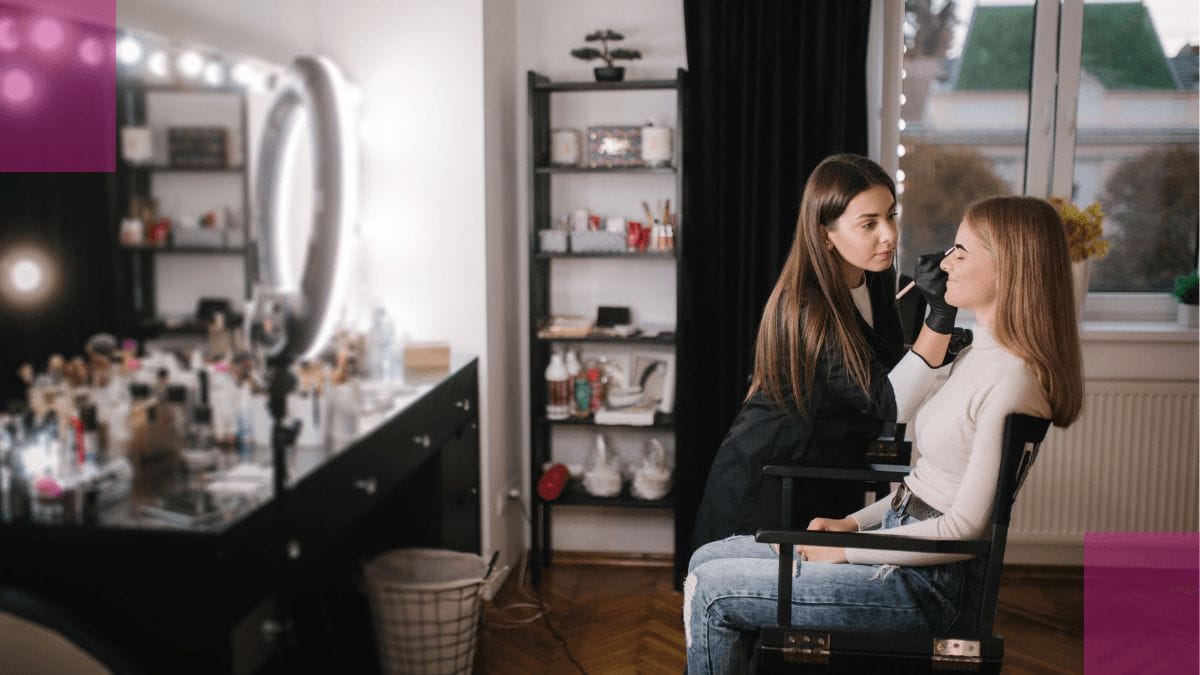 A beauty business owner talks to her client about her emergency fund plan while doing her makeup.