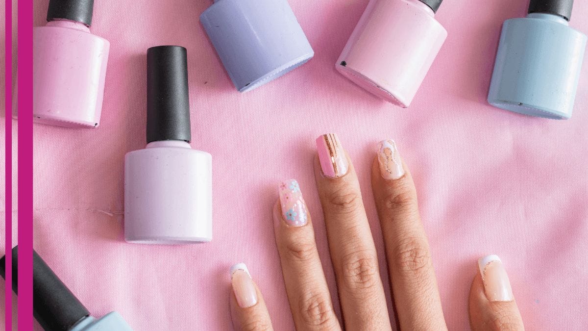 A nail tech holds her hand up to a backdrop, a nail tech business tip she learned for getting a gauge on the right color for skin tone.