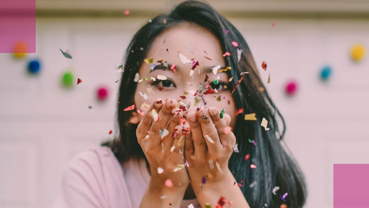 women-in-the-beauty-industry A women blows confetti to celebrate women in the beauty industry during women's month.