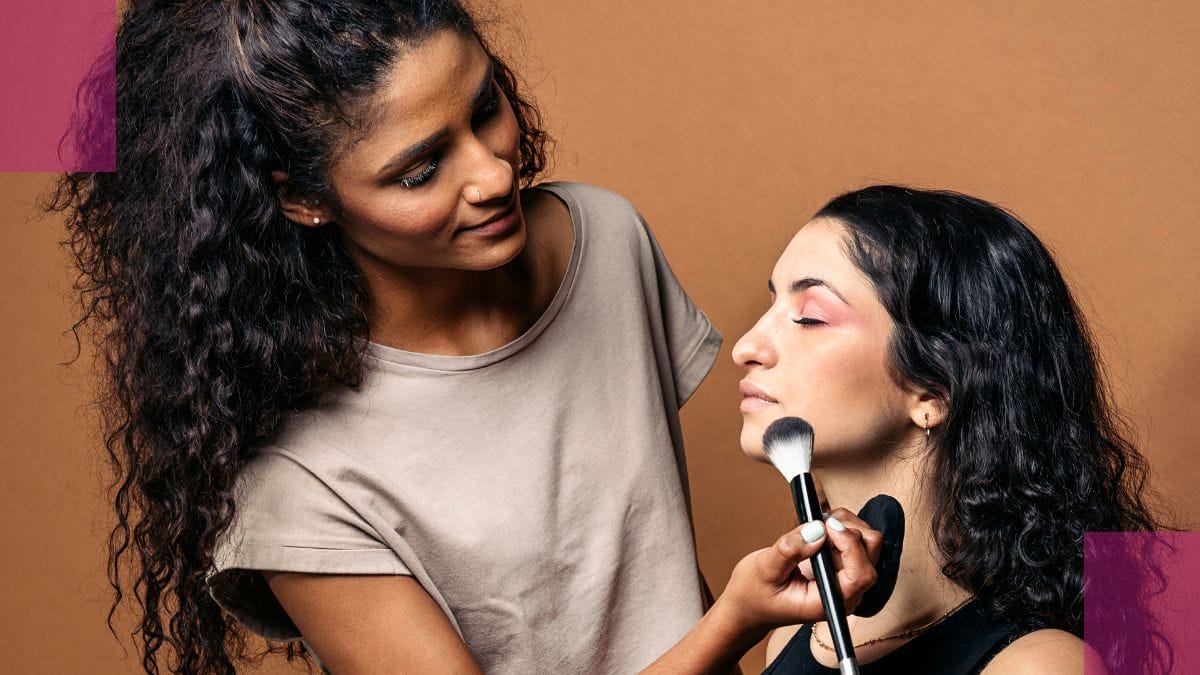 A client gets her makeup done by her makeup artist.