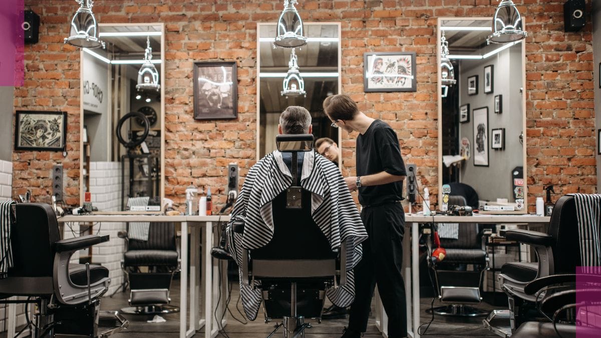 A barber finalizes his client's look and then talks to him about liability insurance.