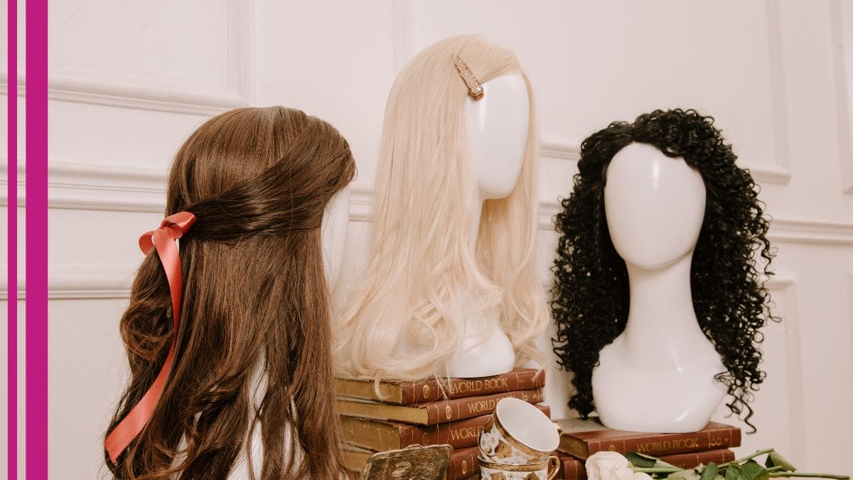 A line of wigs – variety is one of the best wig stylist business tips – are shown in a stylist's salon.