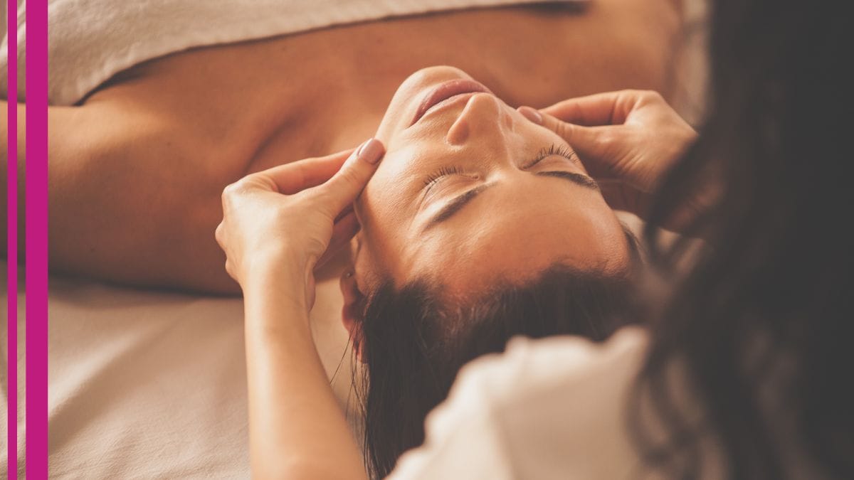 A client feels her beauty pro's hands on her chin during one of her reiki facials.