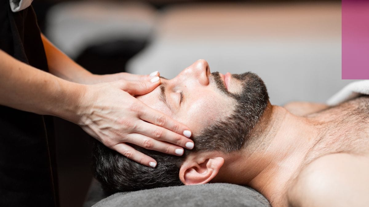 A beauty pro gives her male client one of her reiki facials.
