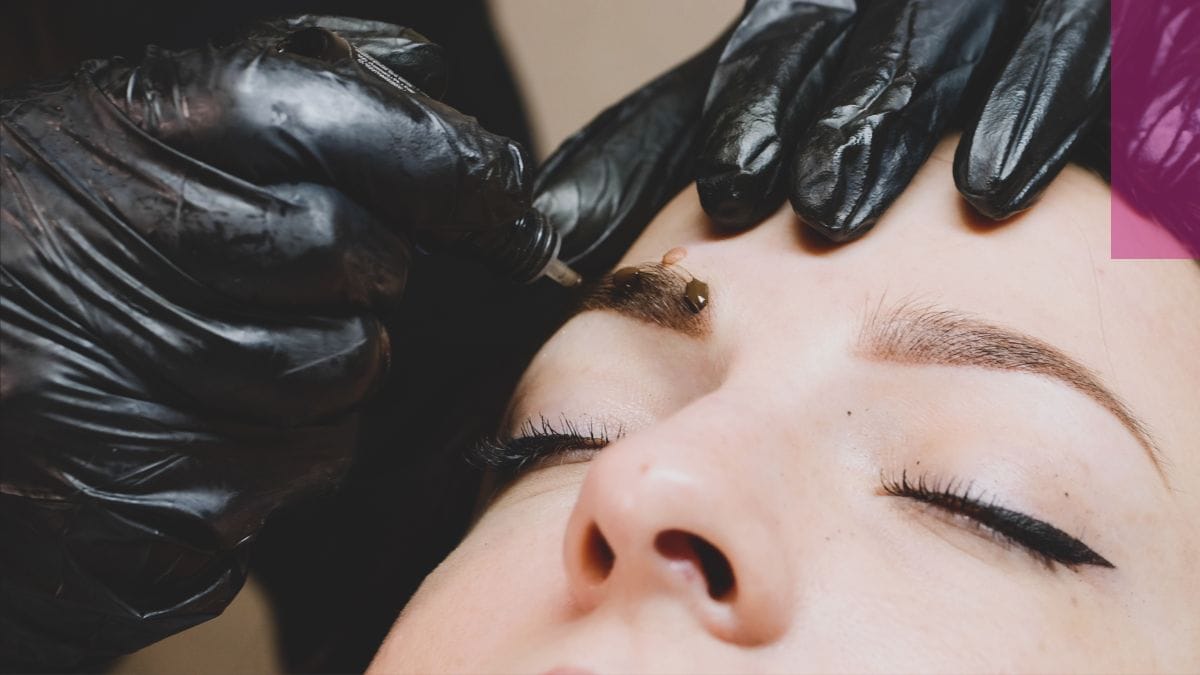 An artist tattoos her client's eyebrows after her microblading certification.