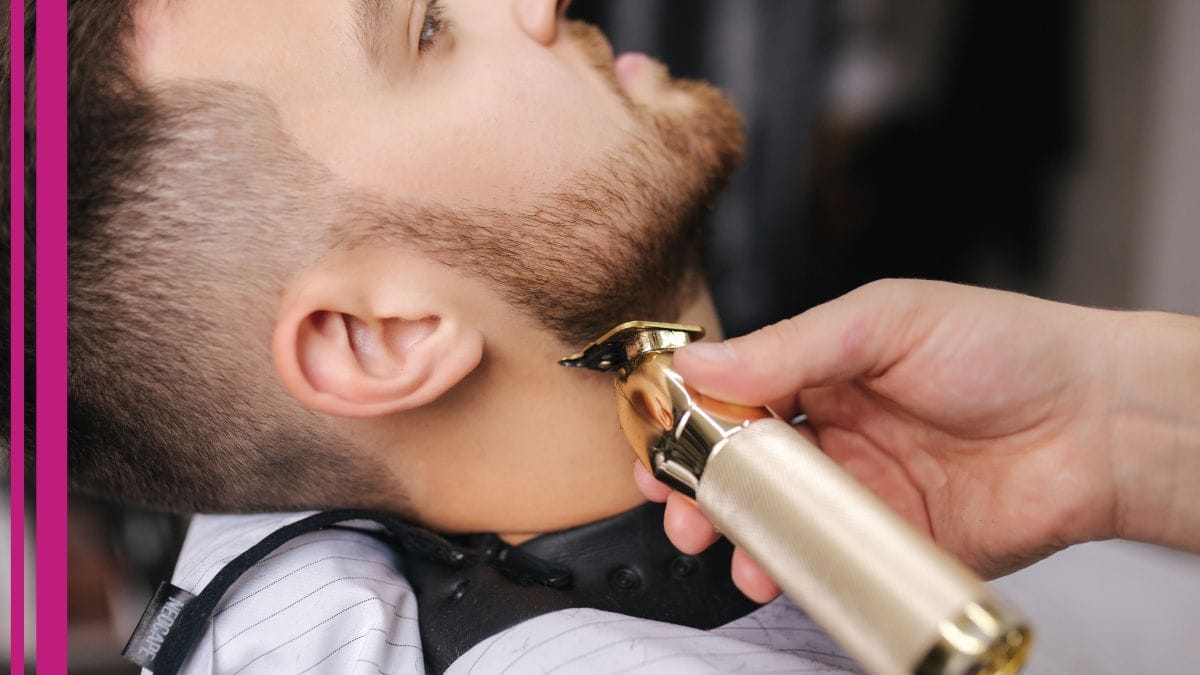 A barber trims his client's beard, knowing his career is protected with barber insurance.