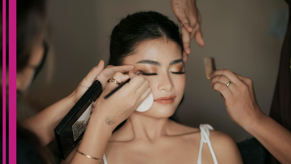 A group of bridal makeup artists help their client get ready for her wedding day.