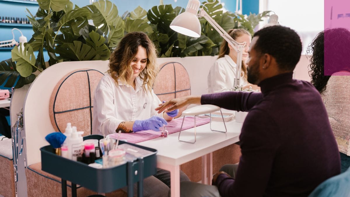 A client wonders how to get rid of green nail syndrome while his esthetician takes care of it. 