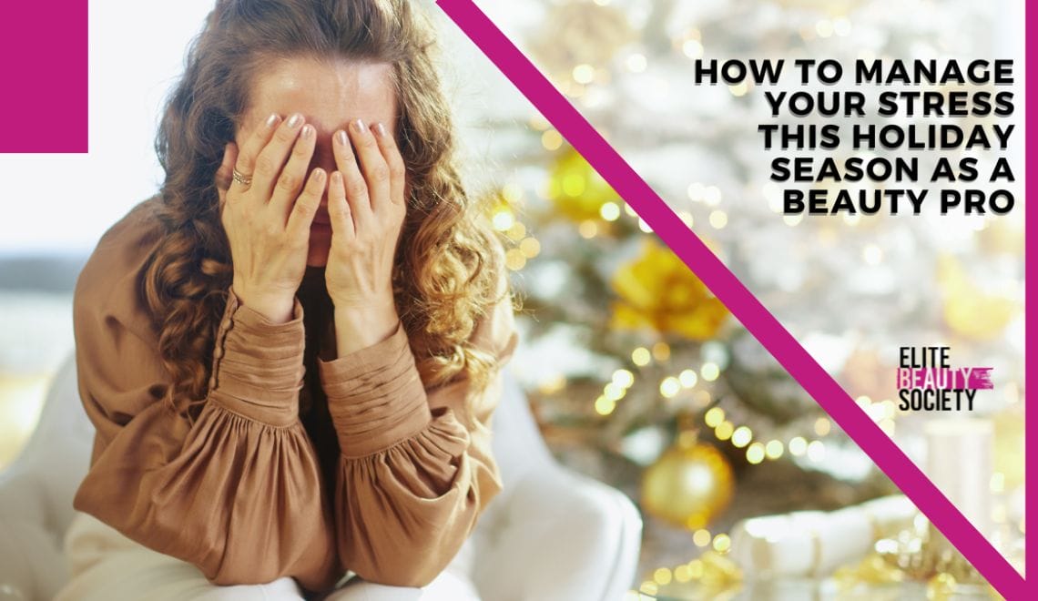 A beauty pro holds her head in her hands, stressed, wondering How to Manage Your Stress This Holiday Season as a Beauty Pro.
