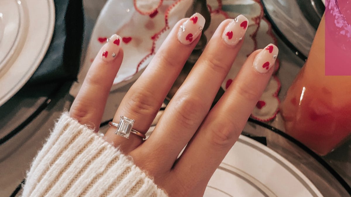 nail design with red hearts and coquette design by nail technician