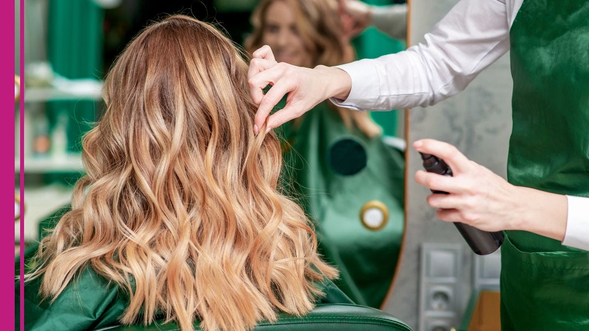 A beauty pro talks to her client about the best cosmetology insurance while doing her hair.