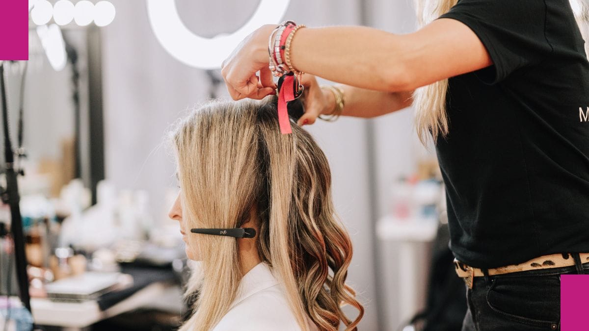 A beauty pro practices at her hair extensions courses.
