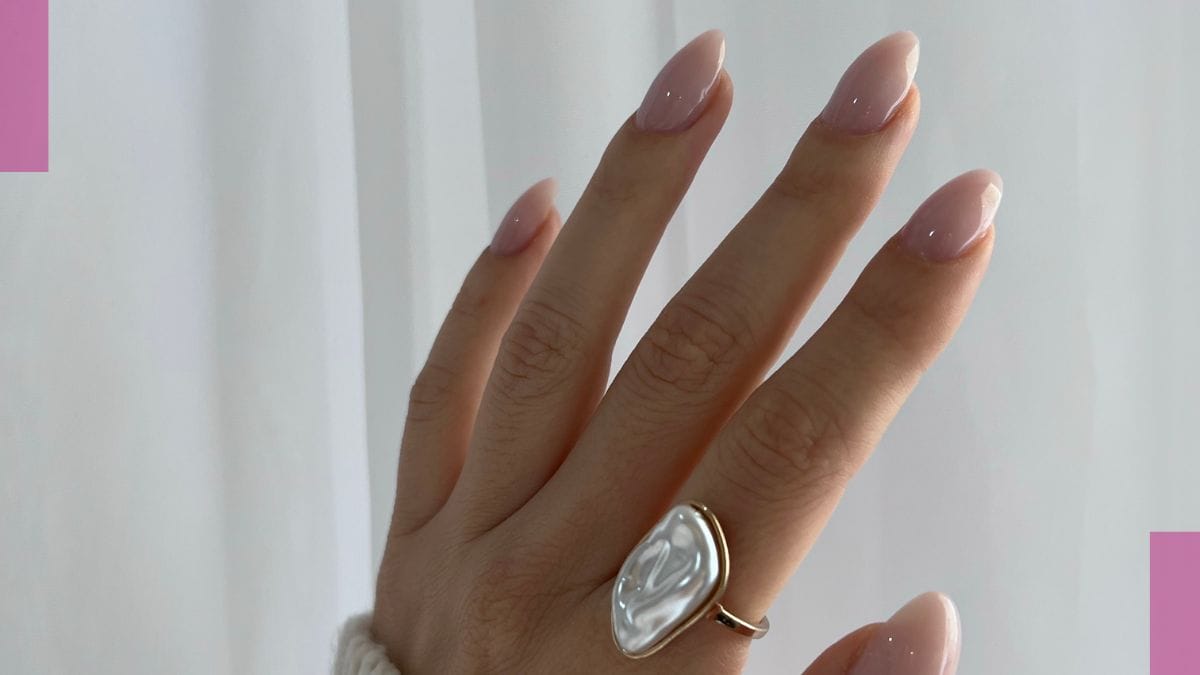 A client shows off her almond shape neutral nails as her spring break nails trend. 